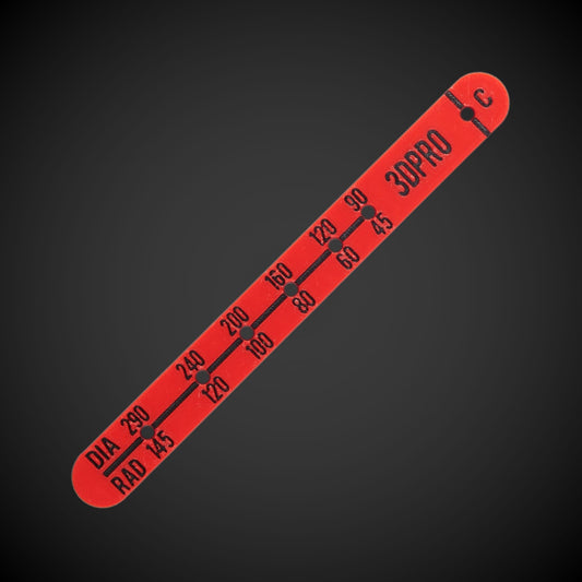 A red plastic ceiling cut-out template tool with various radii measurements printed in black.