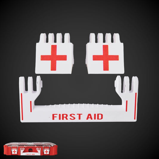 A set of white first aid latches with red text and red crosses, designed for a Milwaukee Packout first aid kit.