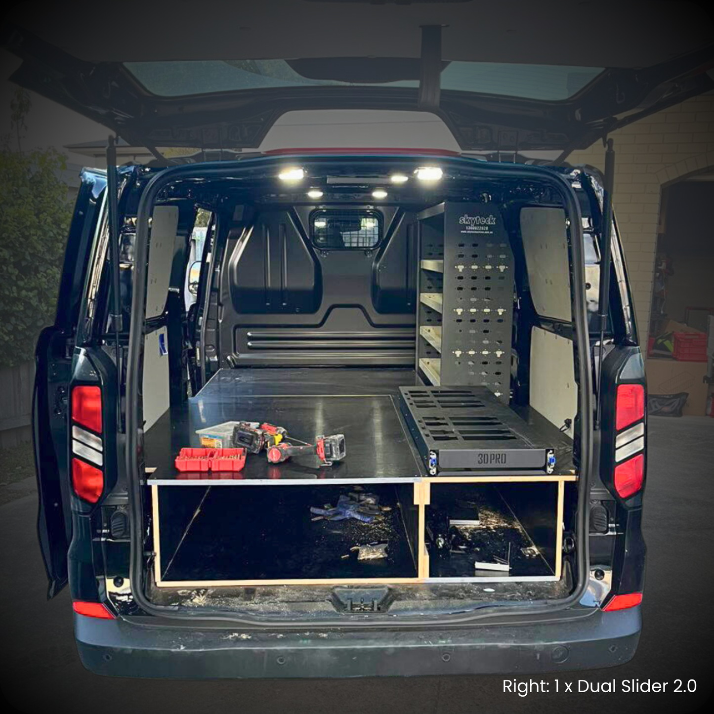 Back of a van with storage shelves and tools inside