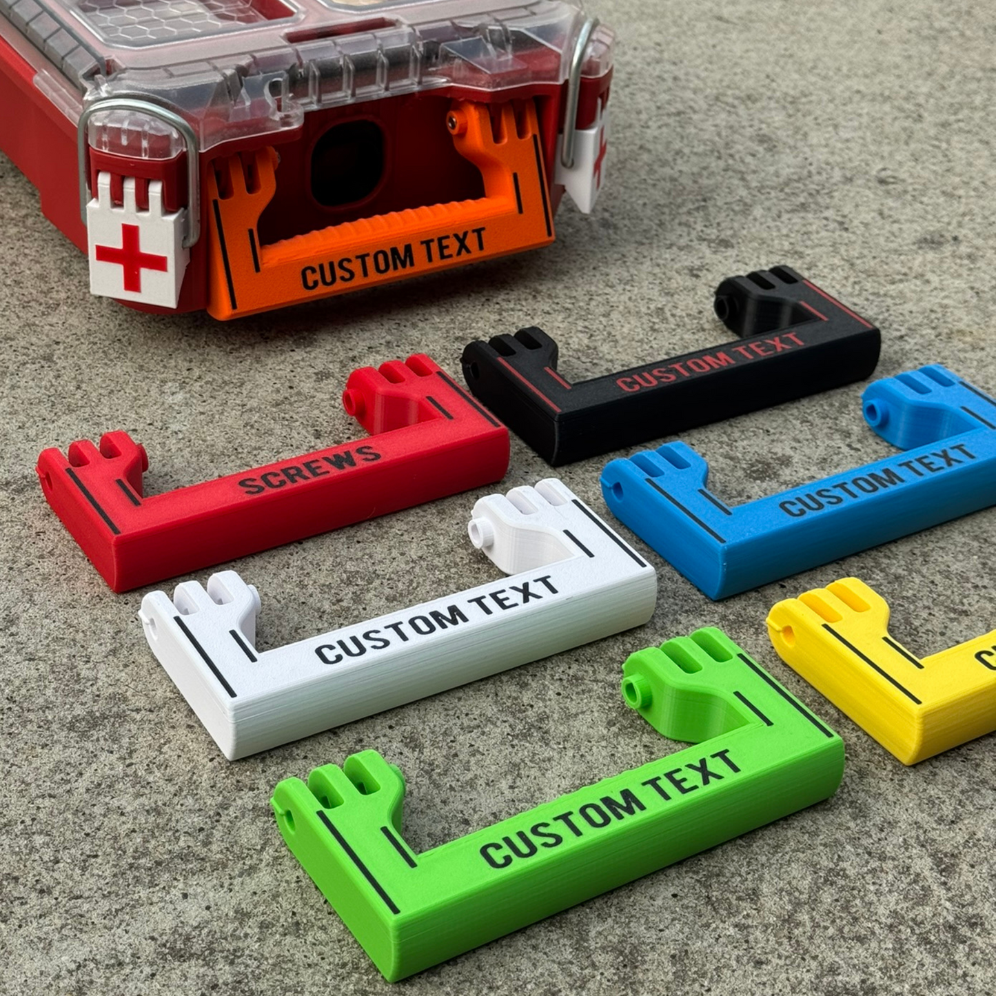 A collection of custom handles in various colors with custom text printed on them, designed for a Milwaukee Standard Packout half width.