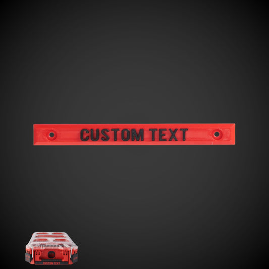 A red custom label with text space for personalization, displayed on a dark background with a miniature red and white checkered box labeled 'CUSTOM TEXT' in the corner.