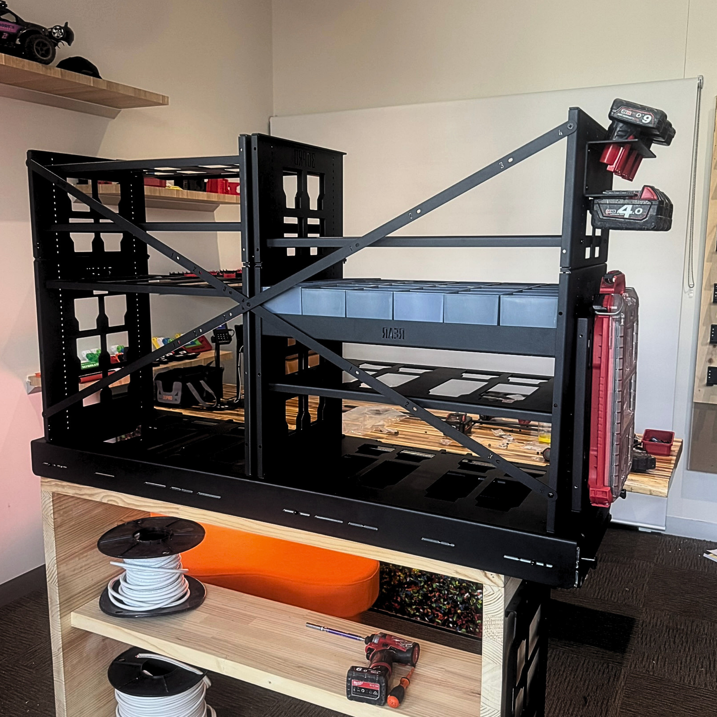 Black metal pack a shleves with 2.0 Slider Bracing Kit (Pack A Shelf) in a room with shelves and items in the background