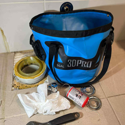 Blue 3DPro folding bucket with tools and materials on a tiled floor