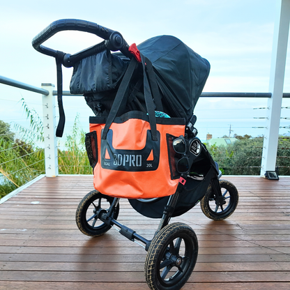 Black stroller with an orange bag featuring 'GOPRO' on a wooden deck.