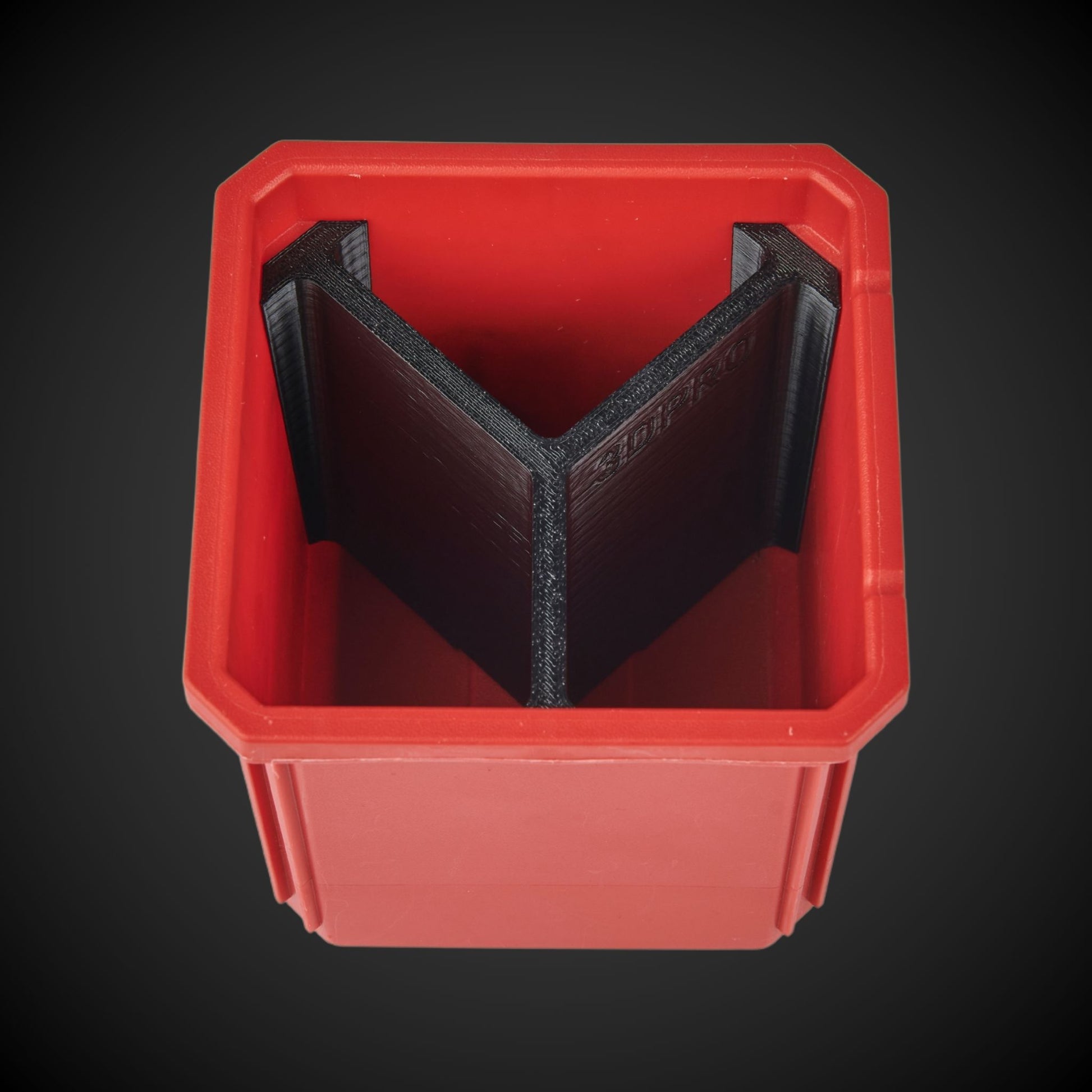 A red plastic bin with a black 3-way standard single bin divider inside, designed to organize items within the bin.