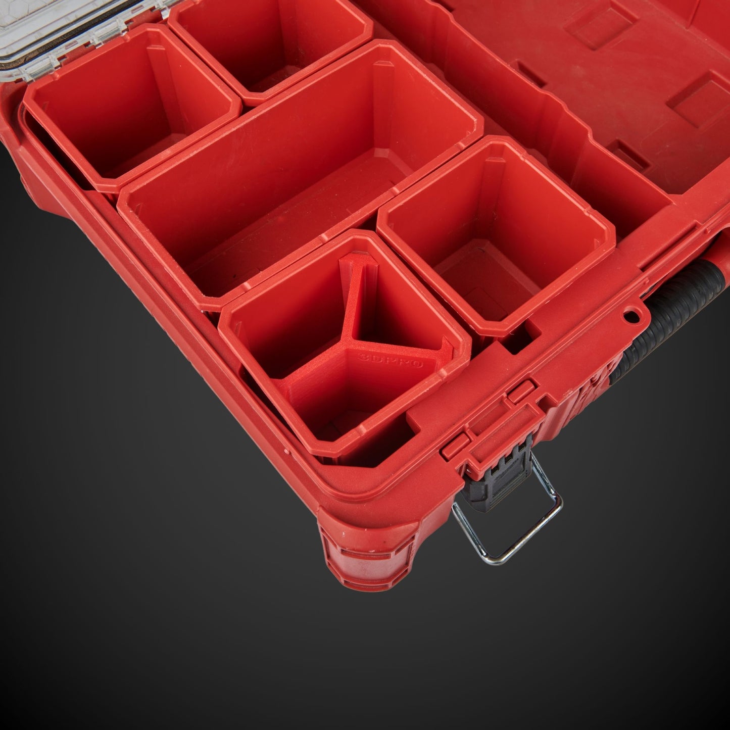 Red tool organizer with multiple compartments on a dark background