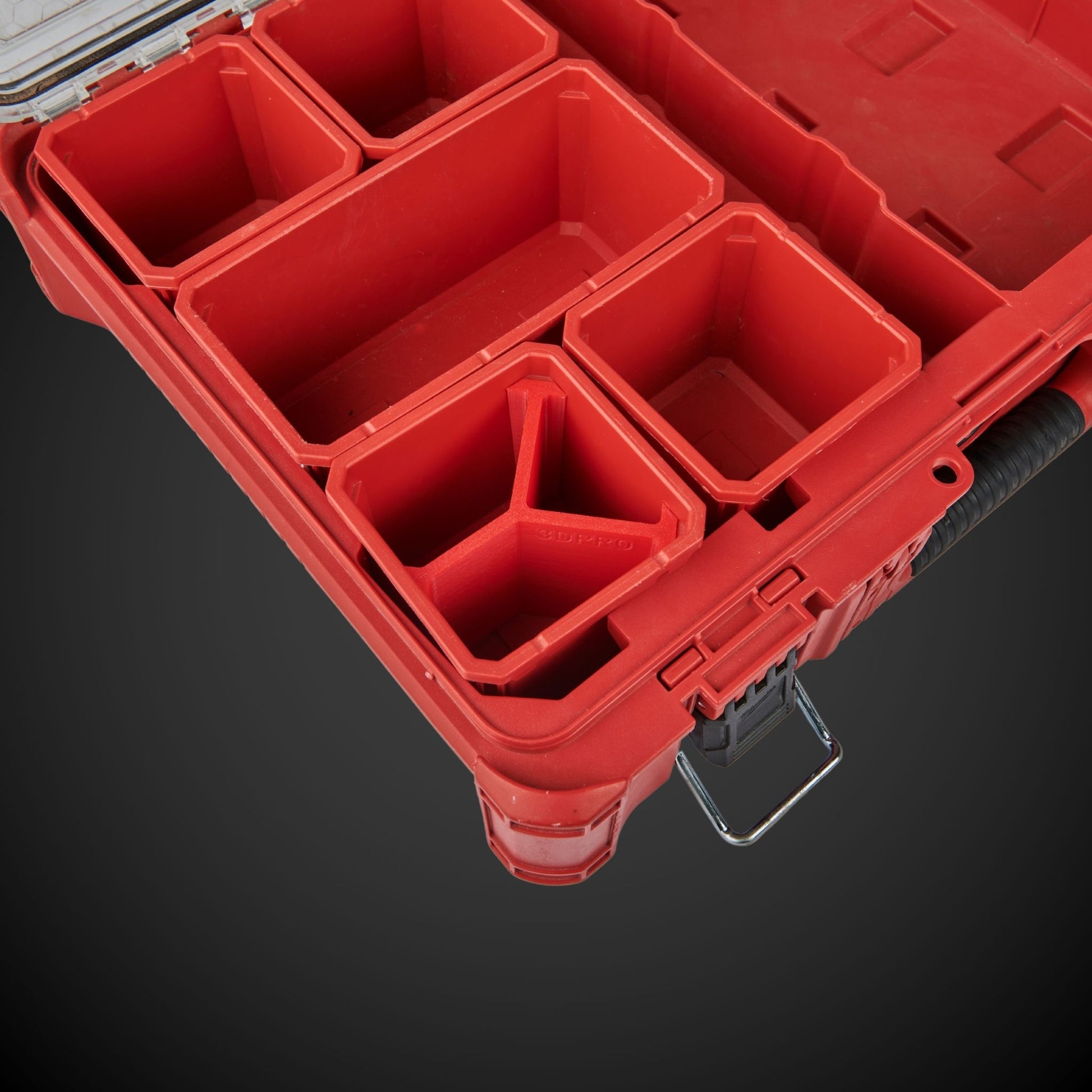 Red tool organizer with multiple compartments on a dark background