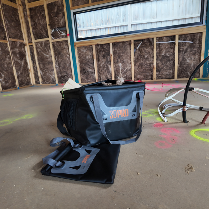 30L/8GAL Pro Square Folding Bucket on a concrete floor with construction elements in the background
