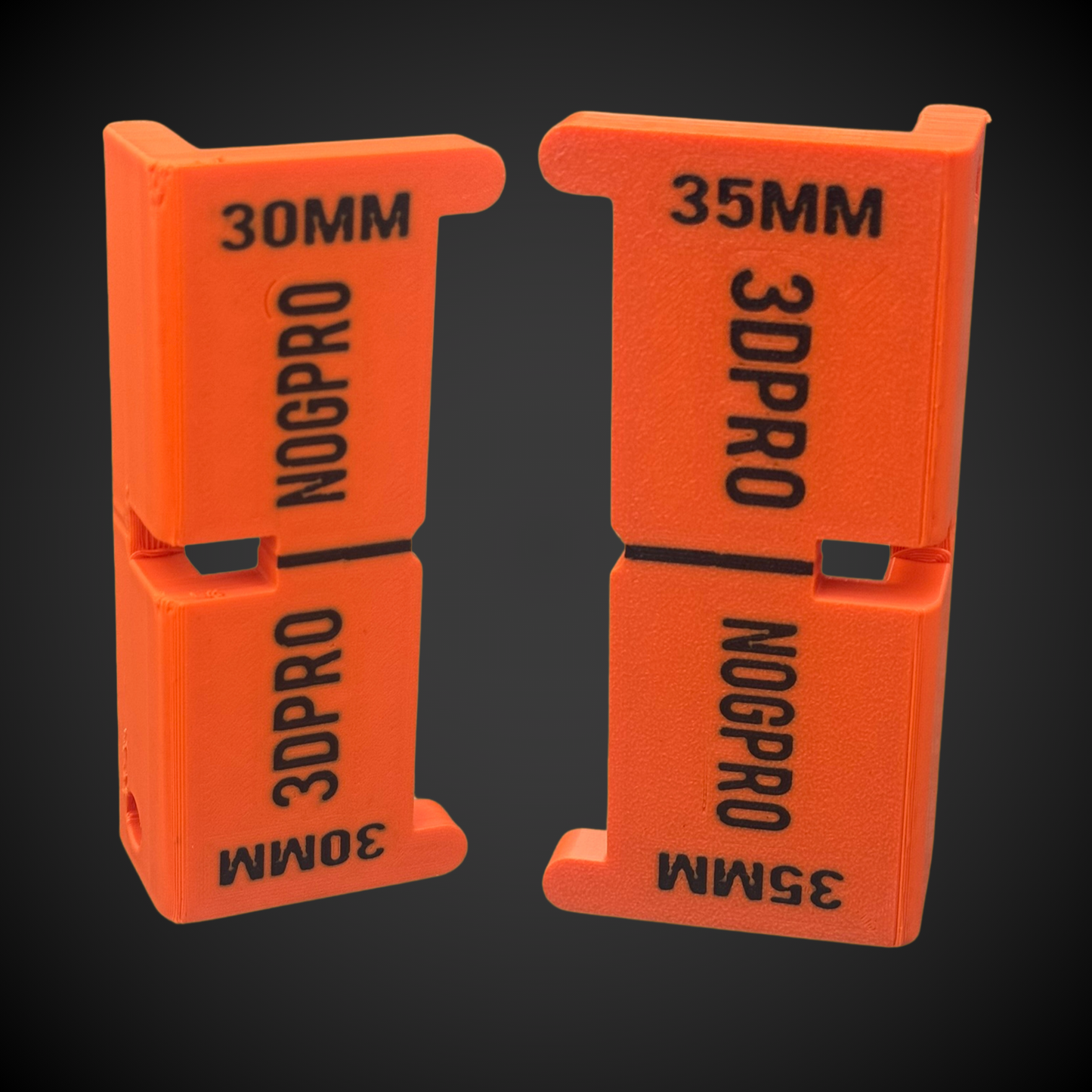 Two orange Nog Pro - Noggin SetBacks with '3DPRO' and 'NOGPRO' branding on a black background