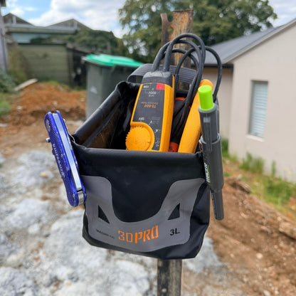 3L Pro Magnetic Folding Bucket On Site with tools including a multimeter and screwdriver on a construction site.