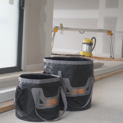 Two black and gray buckets with '3DPRO' branding on a construction site.