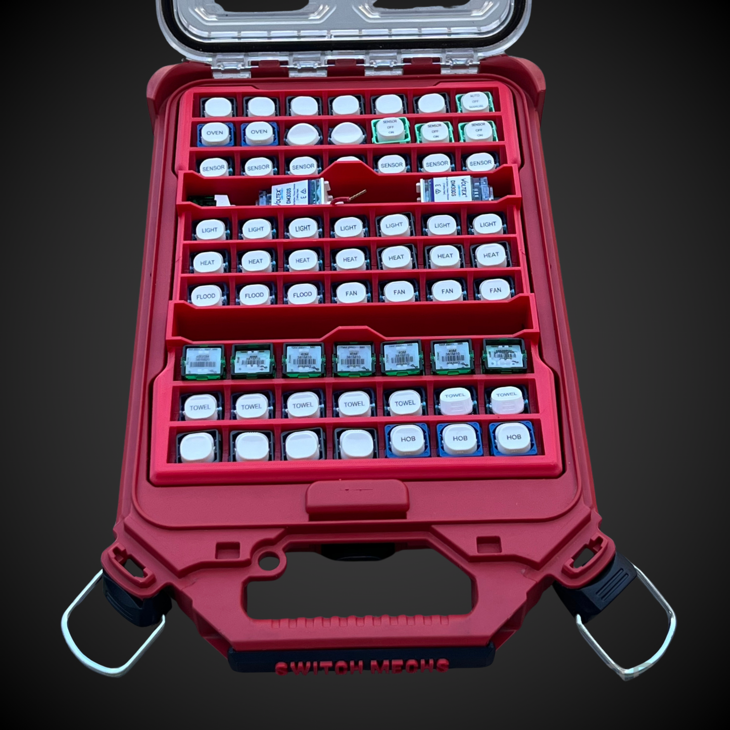 Red case with compartments containing small electronic components on a dark background