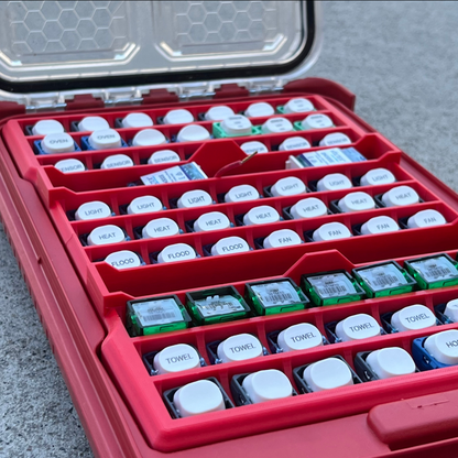 Milwaukee with 63x Switch Mech Insert Packout containing small electronic components on a concrete surface.