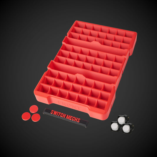 A red 63 x Switch Mech Insert (Packout) with compartments, accompanied by a label that reads 'SWITCH MECHS', and some switch mechs along with 5mm spacers are visible beside it.