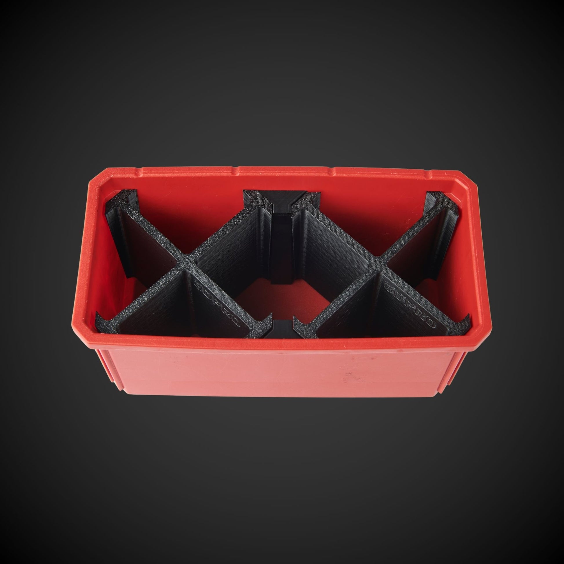 A black 7-way double bin divider inside a red tool storage bin, designed to organize and separate items within the bin.