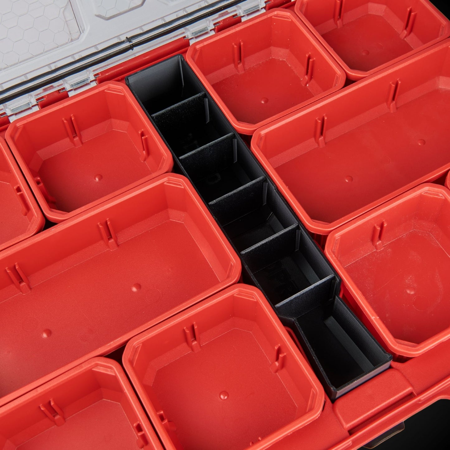 Red storage bins with black Centre Divider Pack (Low Full Width Packout) inside a toolbox