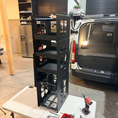 Black metal shelf with tools on a white table in a garage setting