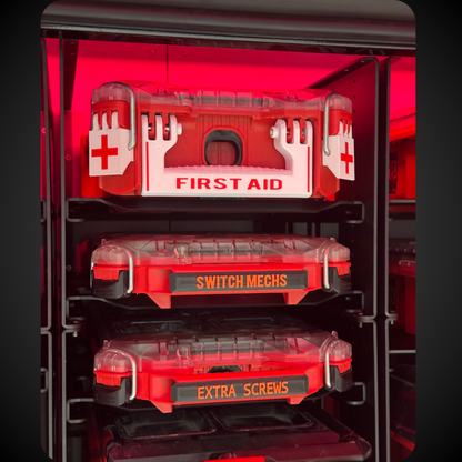 Red tool organizer with compartments labeled 'First Aid', 'Switch Mechs', and 'Extra Screws' on a black background.