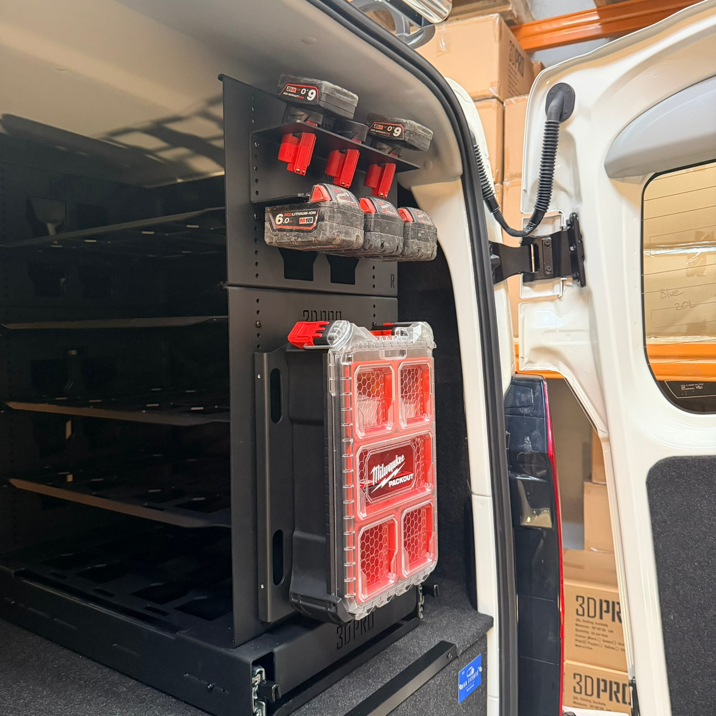 Tool organizer with red and black compartments inside a Hiace Van vehicle.