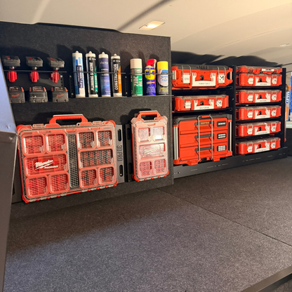 Storage area with red toolboxes and supplies on a gray floor.