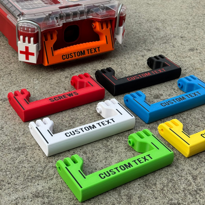 A collection of custom handles in various colors with custom text printed on them, designed for a Milwaukee Standard Packout half width.