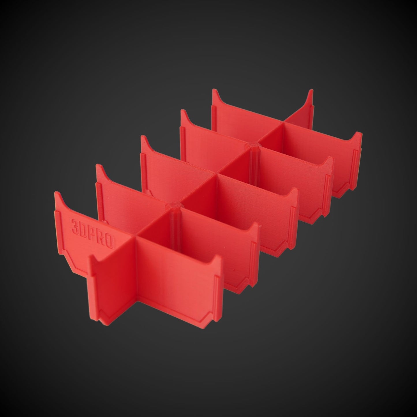 Red plastic grid with 2-Way Low Double Bin Divider on a dark background