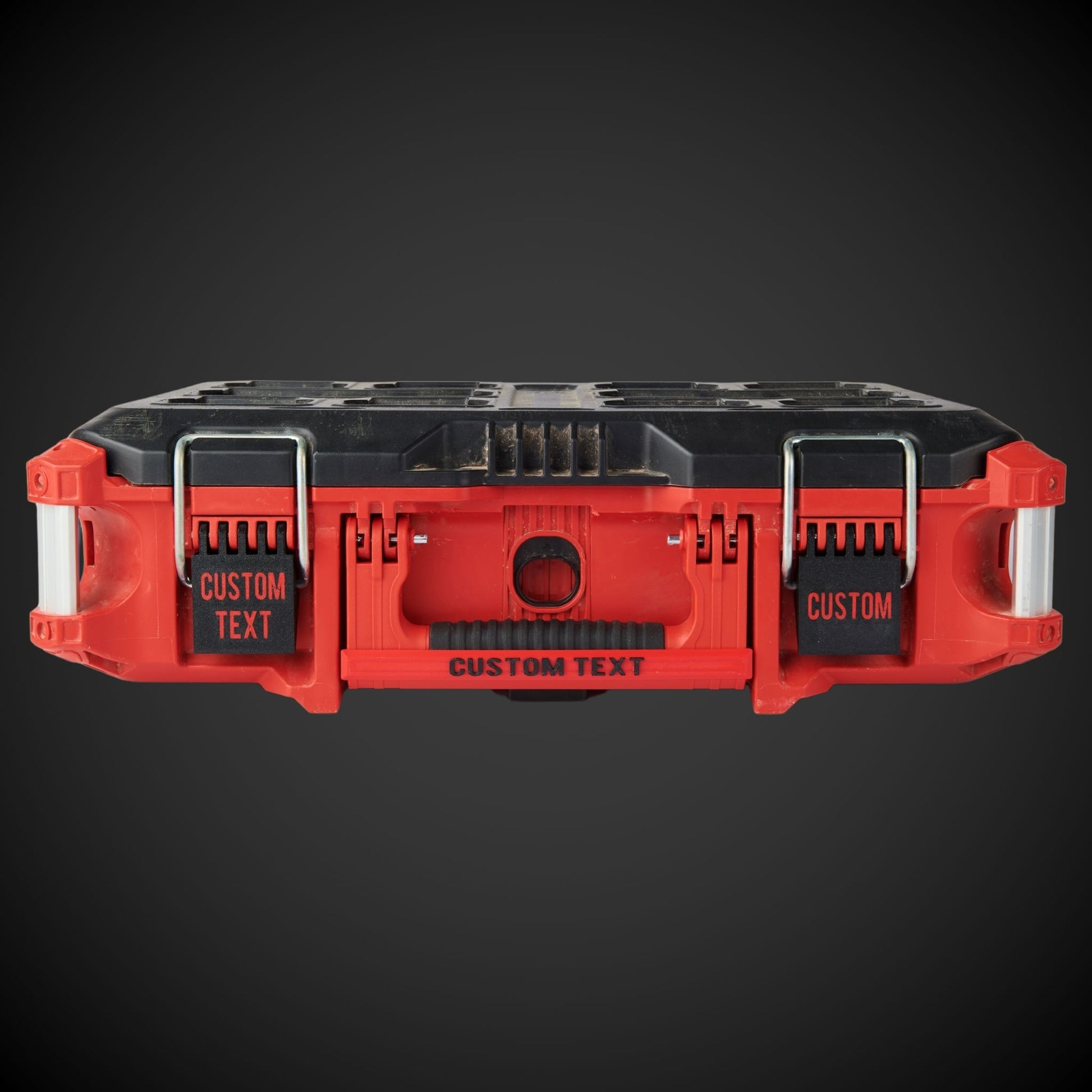 Red and black tool organizer with customizable text on a dark background