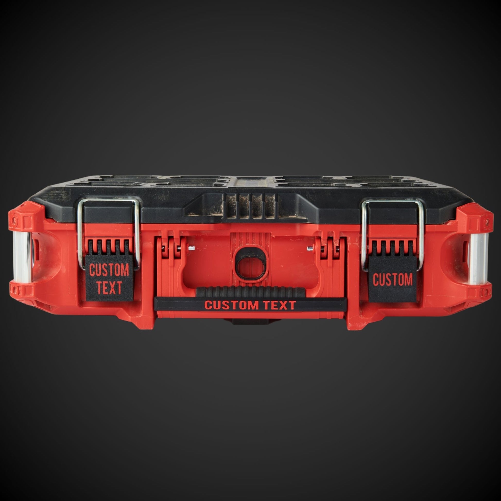 Red and black tool organizer with customizable text on a dark background