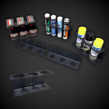 Collection of spray cans and tools on a dark background